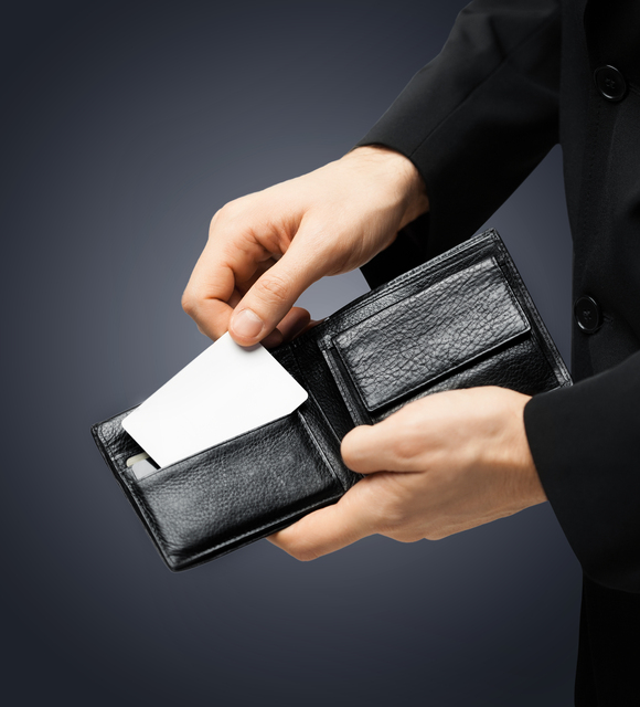 man in suit with wallet and credit card